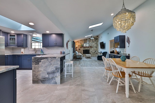 475 Spruceview Dr, Port Orange, FL 32127 - dining space with a skylight, a fireplace, lofted ceiling, and recessed lighting