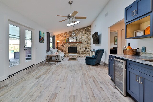 475 Spruceview Dr, Port Orange, FL 32127 - living area with wine cooler, lofted ceiling, ceiling fan, light wood finished floors, and a stone fireplace
