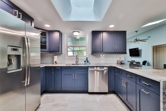 475 Spruceview Dr, Port Orange, FL 32127 - kitchen with stainless steel appliances, a sink, a peninsula, tasteful backsplash, and vaulted ceiling
