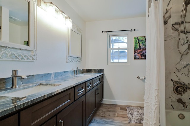 475 Spruceview Dr, Port Orange, FL 32127 - bathroom with double vanity, wood finished floors, shower / bath combo with shower curtain, and baseboards
