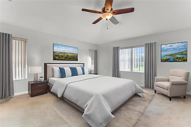 484 Sweet Bay Ave, New Smyrna Beach, FL 32168 - bedroom with baseboards, light carpet, and a ceiling fan