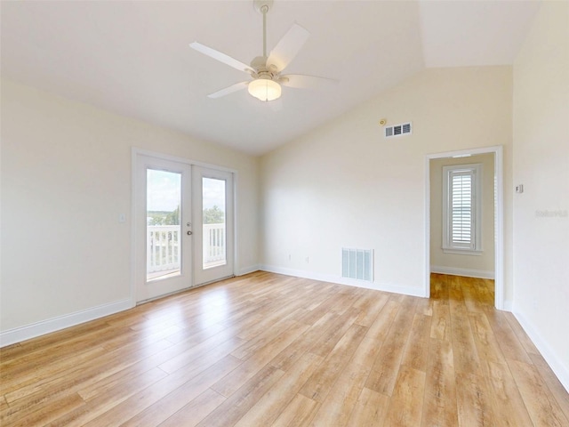 2950 Sunset Dr, New Smyrna Beach, FL 32168 - spare room featuring french doors, vaulted ceiling, light wood-type flooring, a ceiling fan, and baseboards