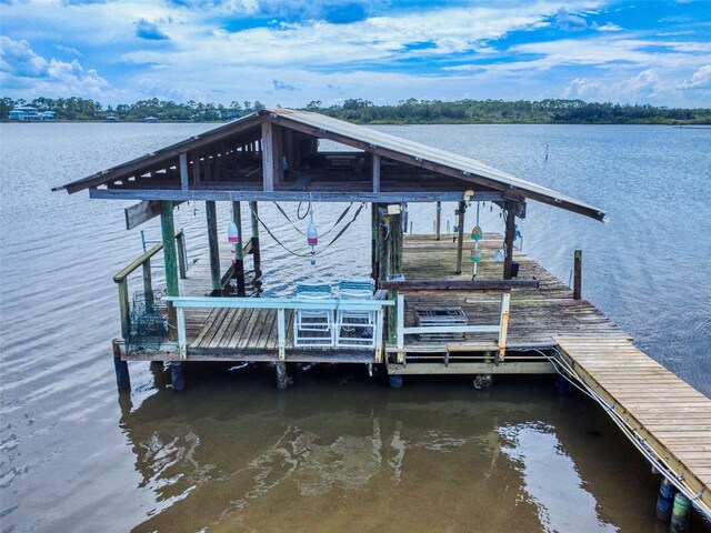 2950 Sunset Dr, New Smyrna Beach, FL 32168 - dock area featuring a water view and boat lift