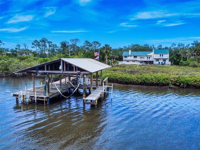 2950 Sunset Dr, New Smyrna Beach, FL 32168 - dock area featuring boat lift, a water view, and view of scattered trees