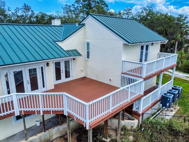 2950 Sunset Dr, New Smyrna Beach, FL 32168 - rear view of house featuring french doors, a standing seam roof, and metal roof
