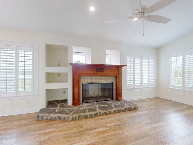 2950 Sunset Dr, New Smyrna Beach, FL 32168 - living area with wood finished floors, baseboards, and a glass covered fireplace