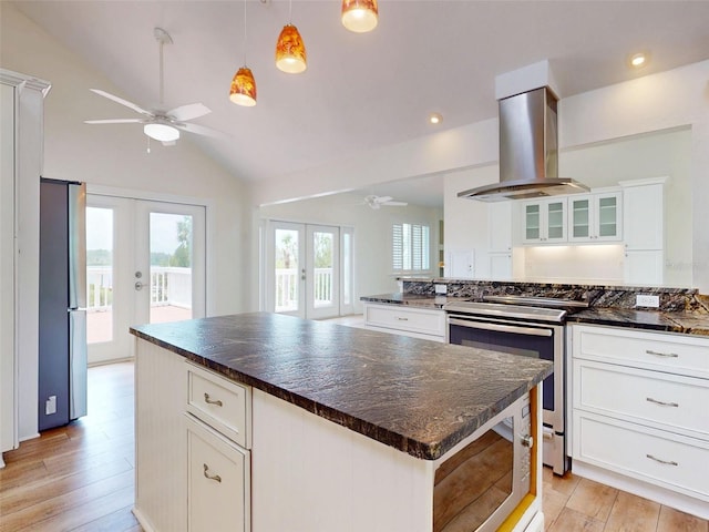 2950 Sunset Dr, New Smyrna Beach, FL 32168 - kitchen featuring french doors, ceiling fan, stainless steel appliances, island range hood, and vaulted ceiling
