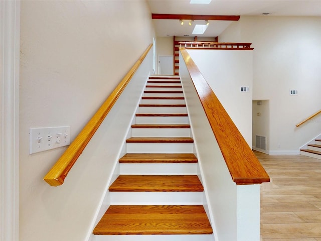2950 Sunset Dr, New Smyrna Beach, FL 32168 - stairs featuring a skylight and wood finished floors