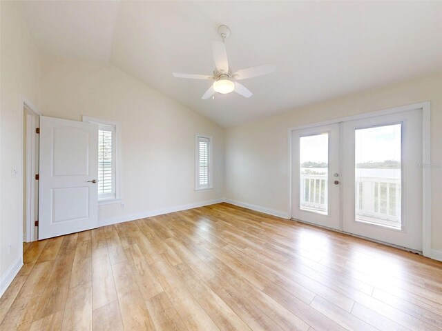 2950 Sunset Dr, New Smyrna Beach, FL 32168 - spare room with french doors, vaulted ceiling, light wood-style flooring, a ceiling fan, and baseboards