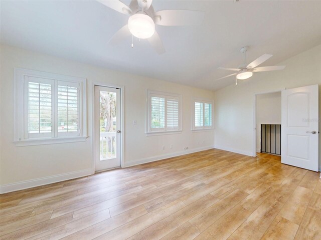 2950 Sunset Dr, New Smyrna Beach, FL 32168 - spare room featuring a ceiling fan, light wood finished floors, vaulted ceiling, and baseboards