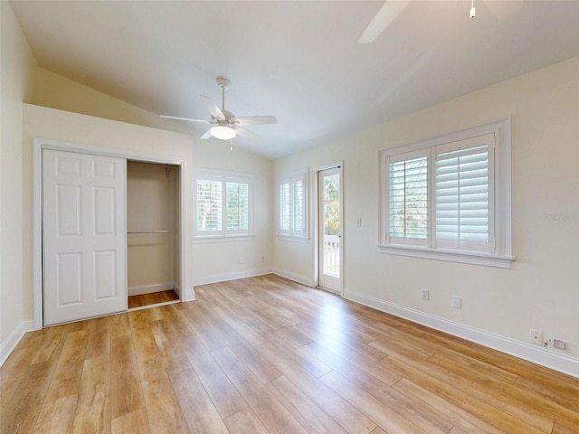 2950 Sunset Dr, New Smyrna Beach, FL 32168 - unfurnished bedroom featuring light wood finished floors, access to exterior, lofted ceiling, baseboards, and a closet