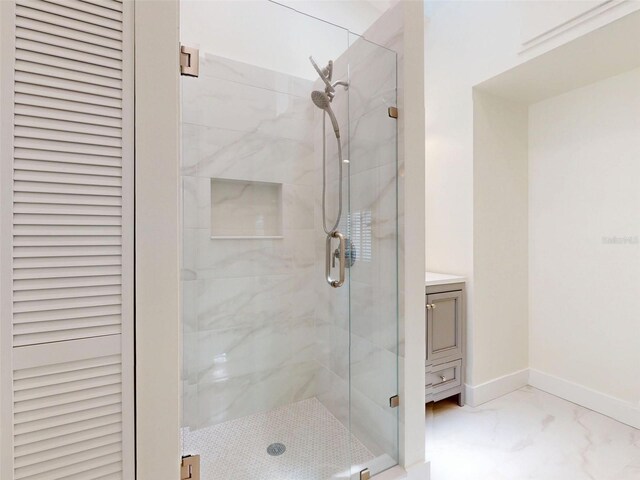 2950 Sunset Dr, New Smyrna Beach, FL 32168 - full bathroom with a shower stall, marble finish flooring, baseboards, and vanity