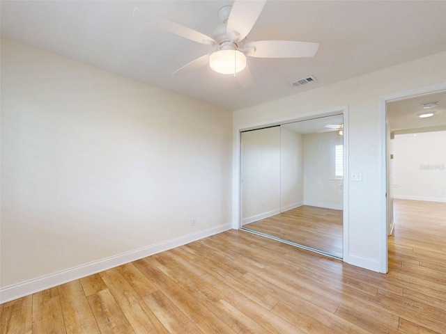 2950 Sunset Dr, New Smyrna Beach, FL 32168 - unfurnished bedroom with light wood-type flooring, a closet, baseboards, and ceiling fan