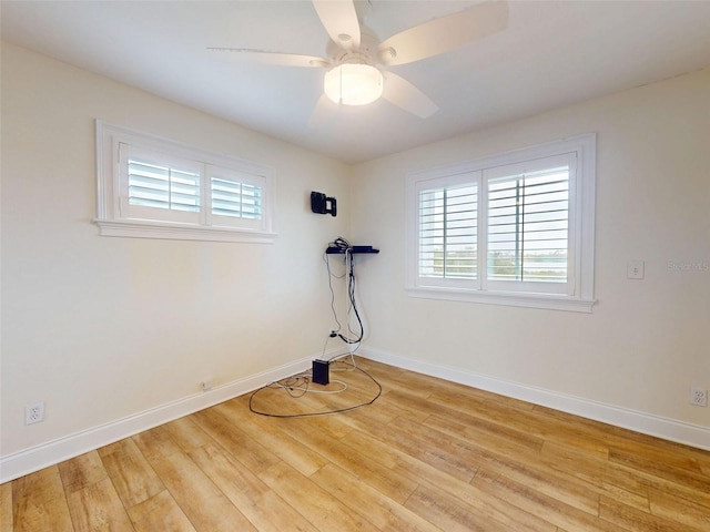 2950 Sunset Dr, New Smyrna Beach, FL 32168 - unfurnished room featuring healthy amount of natural light, wood finished floors, a ceiling fan, and baseboards