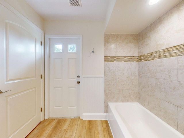 2950 Sunset Dr, New Smyrna Beach, FL 32168 - full bathroom with wood finished floors and a wainscoted wall