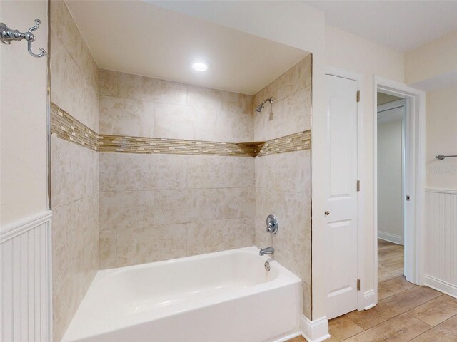 2950 Sunset Dr, New Smyrna Beach, FL 32168 - full bath with shower / bath combination, wood finished floors, wainscoting, and a decorative wall