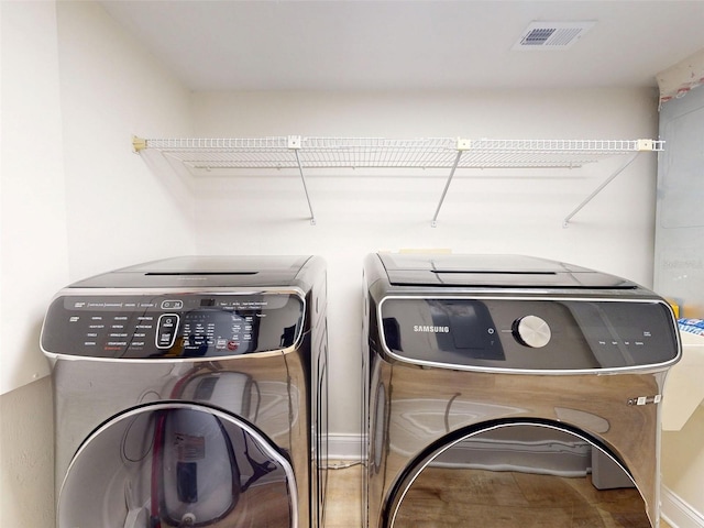 2950 Sunset Dr, New Smyrna Beach, FL 32168 - laundry area featuring independent washer and dryer and baseboards