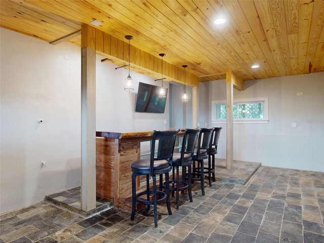 2950 Sunset Dr, New Smyrna Beach, FL 32168 - indoor bar featuring wooden ceiling, stone tile floors, recessed lighting, and decorative light fixtures