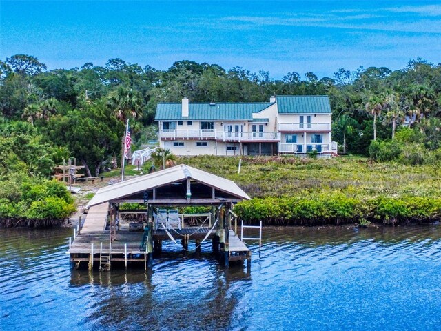 2950 Sunset Dr, New Smyrna Beach, FL 32168 - dock with boat lift, a water view, and a forest view
