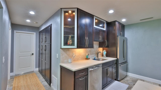 798 Fairway Dr, New Smyrna Beach, FL 32168 - kitchen with a sink, appliances with stainless steel finishes, baseboards, decorative backsplash, and light countertops