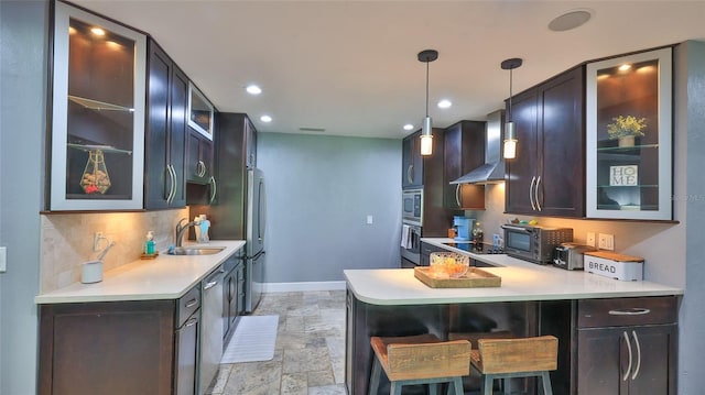 798 Fairway Dr, New Smyrna Beach, FL 32168 - kitchen with a sink, wall chimney exhaust hood, decorative backsplash, baseboards, and a peninsula