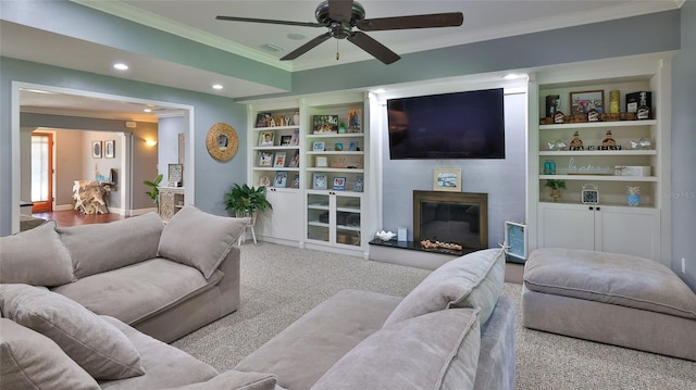 798 Fairway Dr, New Smyrna Beach, FL 32168 - carpeted living room with ornamental molding, a glass covered fireplace, ceiling fan, recessed lighting, and built in shelves
