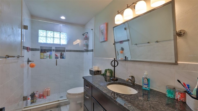 798 Fairway Dr, New Smyrna Beach, FL 32168 - bathroom featuring tile walls, a shower stall, vanity, and toilet