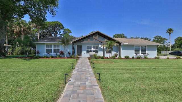 798 Fairway Dr, New Smyrna Beach, FL 32168 - ranch-style home with stucco siding and a front lawn