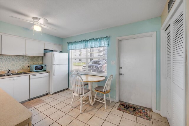 525 N Atlantic Ave Unit 39, New Smyrna Beach, FL 32169 - kitchen with white appliances, white cabinets, light countertops, and a sink