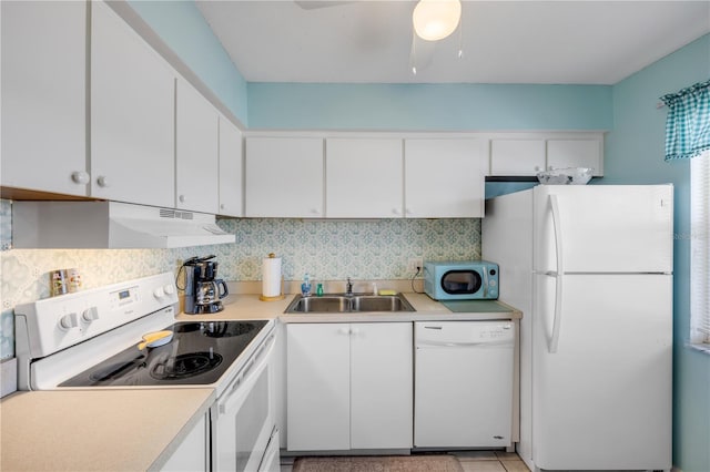 525 N Atlantic Ave Unit 39, New Smyrna Beach, FL 32169 - kitchen featuring white appliances, a sink, under cabinet range hood, and light countertops