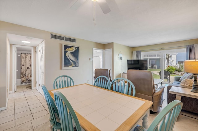 525 N Atlantic Ave Unit 39, New Smyrna Beach, FL 32169 - dining area featuring a ceiling fan, light tile patterned flooring, and baseboards