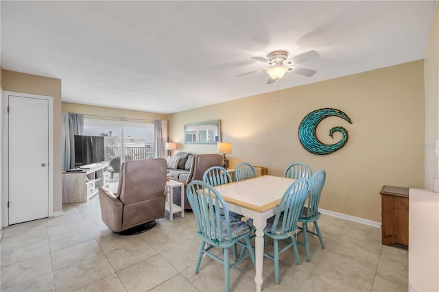 525 N Atlantic Ave Unit 39, New Smyrna Beach, FL 32169 - dining room featuring ceiling fan, light tile patterned floors, and baseboards