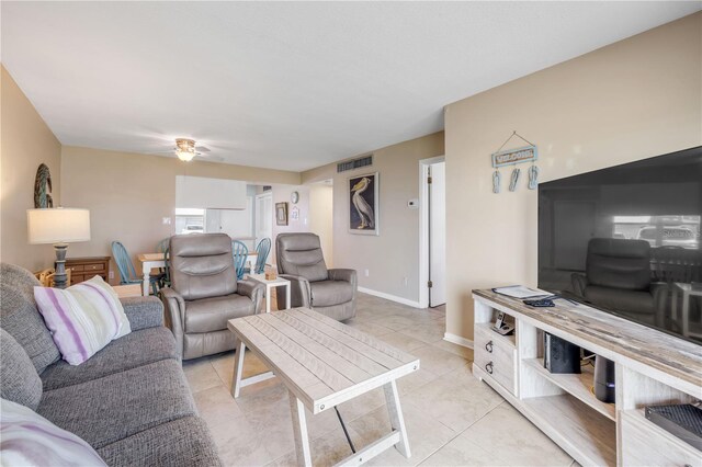 525 N Atlantic Ave Unit 39, New Smyrna Beach, FL 32169 - living room with a ceiling fan, light tile patterned flooring, and baseboards