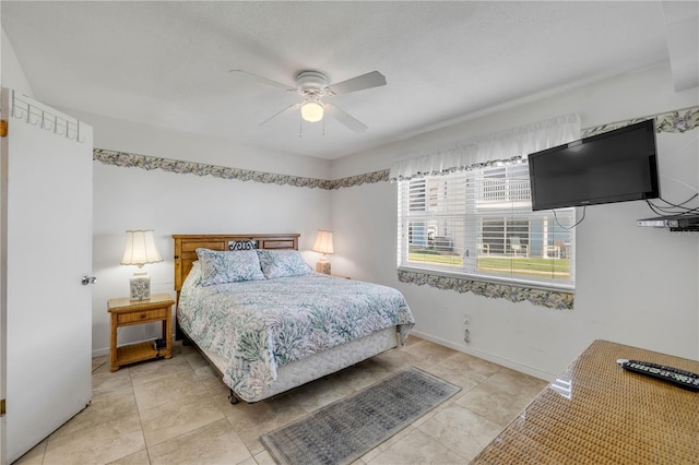 525 N Atlantic Ave Unit 39, New Smyrna Beach, FL 32169 - bedroom featuring ceiling fan, baseboards, and light tile patterned flooring