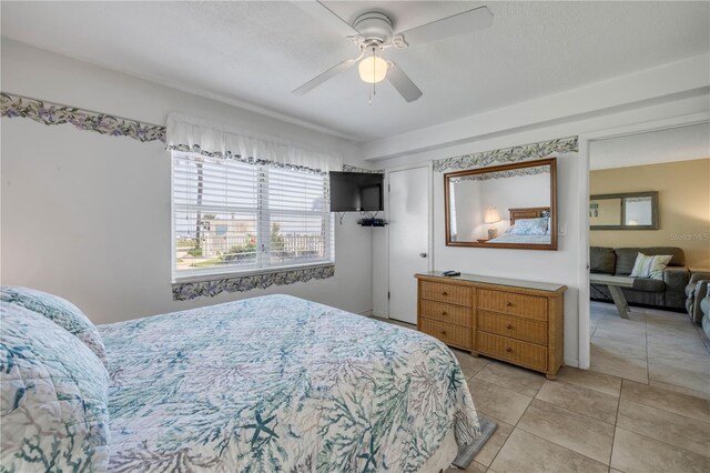 525 N Atlantic Ave Unit 39, New Smyrna Beach, FL 32169 - bedroom with light tile patterned floors and a ceiling fan