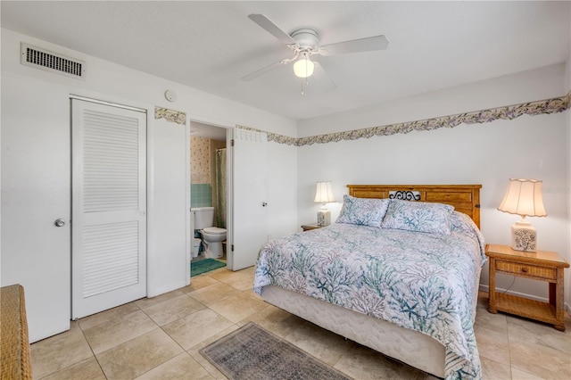525 N Atlantic Ave Unit 39, New Smyrna Beach, FL 32169 - bedroom with light tile patterned floors, connected bathroom, a ceiling fan, and a closet