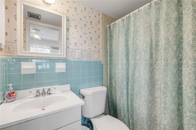 525 N Atlantic Ave Unit 39, New Smyrna Beach, FL 32169 - full bath with toilet, wallpapered walls, vanity, tile walls, and curtained shower
