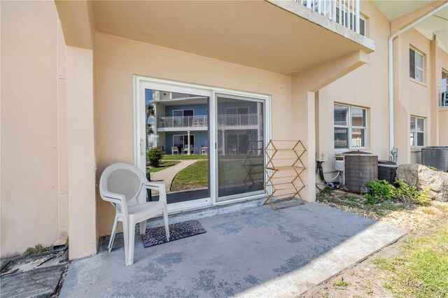 525 N Atlantic Ave Unit 39, New Smyrna Beach, FL 32169 - entrance to property featuring stucco siding, a patio area, and central air condition unit