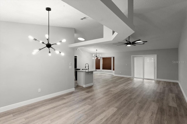2325 Lime Tree Dr, Edgewater, FL 32141 - unfurnished living room with a chandelier, a sink, light wood-type flooring, baseboards, and ceiling fan