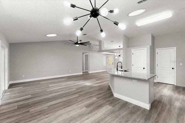 2325 Lime Tree Dr, Edgewater, FL 32141 - kitchen featuring a sink, a chandelier, a textured ceiling, lofted ceiling, and wood finished floors
