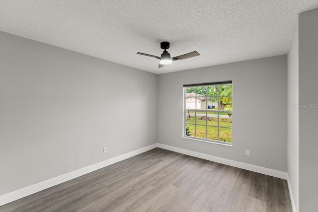 2325 Lime Tree Dr, Edgewater, FL 32141 - unfurnished room featuring dark wood finished floors, ceiling fan, baseboards, and a textured ceiling