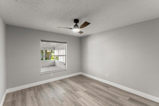 2325 Lime Tree Dr, Edgewater, FL 32141 - spare room featuring wood finished floors, a ceiling fan, baseboards, and a textured ceiling