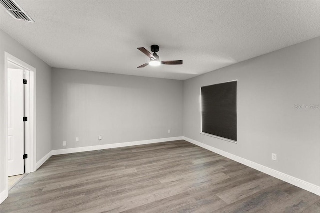 2325 Lime Tree Dr, Edgewater, FL 32141 - empty room with a ceiling fan, wood finished floors, a textured ceiling, and baseboards