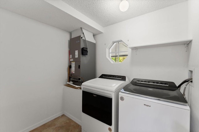 2325 Lime Tree Dr, Edgewater, FL 32141 - laundry area with washing machine and dryer, a textured ceiling, heating unit, and baseboards