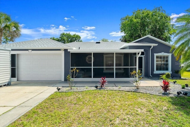 2325 Lime Tree Dr, Edgewater, FL 32141 - view of front of house featuring a garage, a sunroom, a front lawn, and concrete driveway
