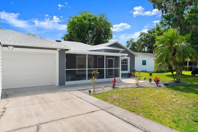 2325 Lime Tree Dr, Edgewater, FL 32141 - view of front of house with a garage, a front yard, concrete driveway, and a sunroom