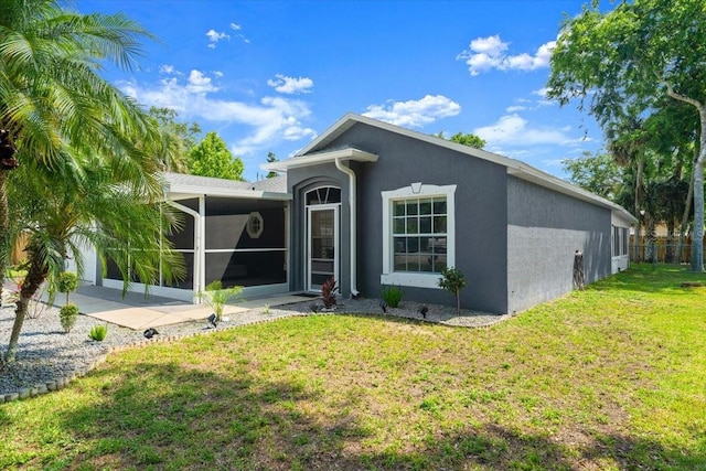 2325 Lime Tree Dr, Edgewater, FL 32141 - back of property with stucco siding, a yard, and a sunroom