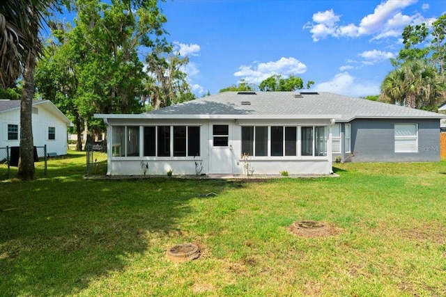 2325 Lime Tree Dr, Edgewater, FL 32141 - rear view of house featuring a sunroom, a yard, and roof with shingles