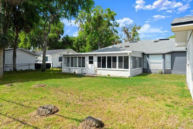 2325 Lime Tree Dr, Edgewater, FL 32141 - back of property featuring a sunroom and roof with shingles