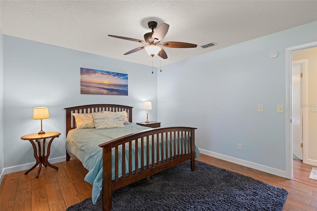 1723 Needle Palm Dr, Edgewater, FL 32132 - bedroom with wood-type flooring, a textured ceiling, and a ceiling fan